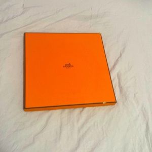 A Hermes Paris scarf, it’s tan, purple, yellow and orange has not been used.